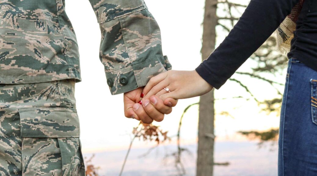 soldier holds hand with wife high unemployment among military wives